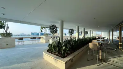 a balcony of a building with a table and chairs at Fendi 1BR with Panoramic Sea View in Dubai