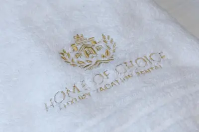 a white envelope with a royal crest on it at Silverene Tower - One Bedroom By Home Of Choice in Dubai