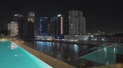 a view of a city at night with a swimming pool at Luxury - Burj Khalifa View - Private Jacuzzi in Dubai