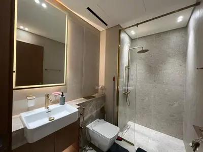 a bathroom with a sink and a toilet and a shower at Luxury - Burj Khalifa View - Private Jacuzzi in Dubai