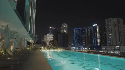 a swimming pool with a city skyline at night at Luxury - Burj Khalifa View - Private Jacuzzi in Dubai