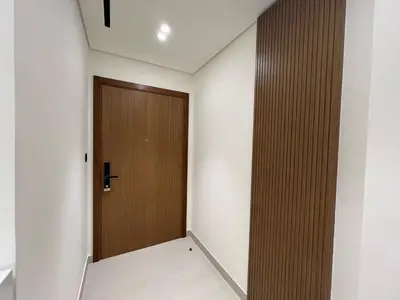 a hallway with a wooden door in a building at Luxury - Burj Khalifa View - Private Jacuzzi in Dubai