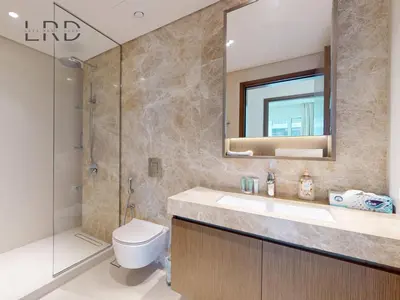 a bathroom with a toilet and a sink and a shower at Waterfront 1 Bedroom Apartment - Private Beach - Emaar Beachfront in Dubai