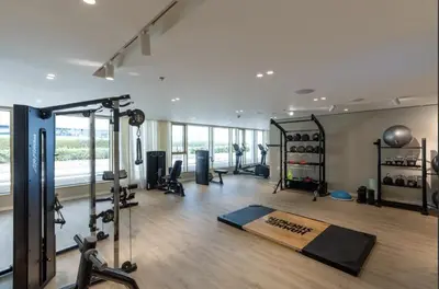 a room with a gym with treadmills and a treadmill at Waterfront 1 Bedroom Apartment - Private Beach - Emaar Beachfront in Dubai