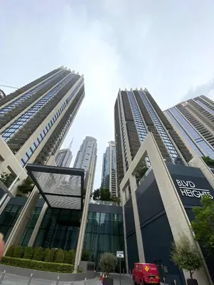 a view of two tall buildings in a city at Silkhaus Serene 1BR at Boulevard Heights in Downtown in Dubai