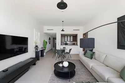 a living room with a couch and a table at Silkhaus Serene 1BR at Boulevard Heights in Downtown in Dubai