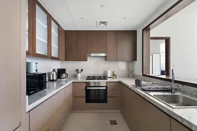 a kitchen with a sink and a stove top oven at Silkhaus Serene 1BR at Boulevard Heights in Downtown in Dubai