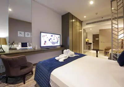 a hotel room with a bed and a television at Stylish Studio Apartment in Dubai with Pool & Gym in Dubai