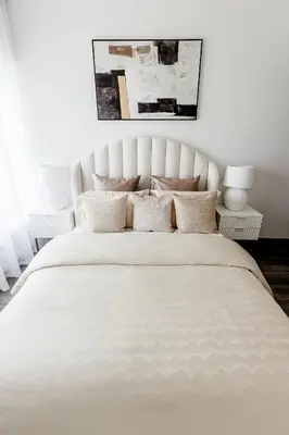 a white bedroom with a large white bed with pillows at Beautiful 3 bed In Dubai Marina! in Dubai