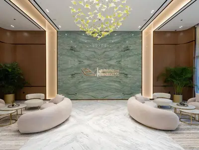 a lobby with chairs and tables and a chandelier at Modern & Smart 1br W Stylish Interiors In Jvc in Dubai