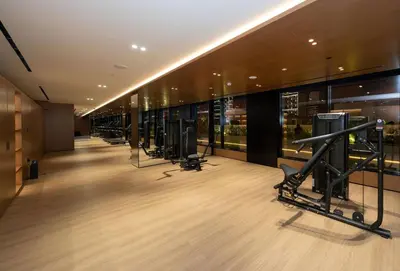 a gym with a row of exercise equipment in a building at Modern & Smart 1br W Stylish Interiors In Jvc in Dubai
