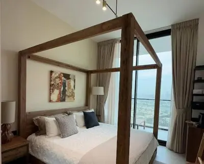 a bedroom with a canopy bed with a large window at Modern & Smart 1br W Stylish Interiors In Jvc in Dubai