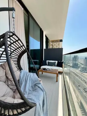 a room with a rattan chair on a balcony at Modern & Smart 1br W Stylish Interiors In Jvc in Dubai