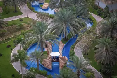 an aerial view of a water park with a water slide at Palm Home next to Nakheel Mall with Private Beach in Dubai