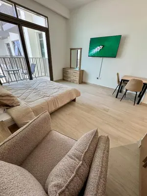 a living room with a bed and a couch at Dubai - Brand New Apartment in Dubai