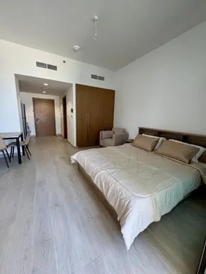a large bedroom with a large bed and a table at Dubai - Brand New Apartment in Dubai