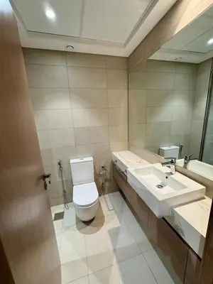a bathroom with a toilet and a sink at Dubai - Brand New Apartment in Dubai