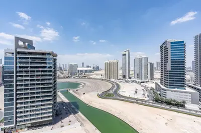 a view of a city with tall buildings and a river at Premium & Cozy Home in the Heart of Sports City in Dubai
