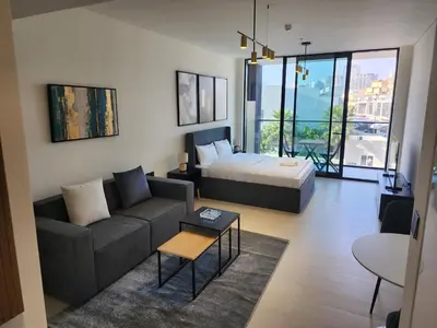 a living room with a couch and a bed at Disalvo Smart and Luxury Studio in Dubai