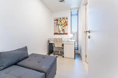 a living room with a couch and a desk at 2BR with Balcony, Exclusive Amenities and Steps from Iconic Landmarks, Madinat Jumeirah Living Rahaal 2, Jumeirah in Dubai