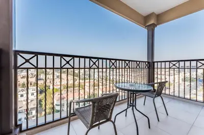 a balcony with a table and chairs and a view at 2BR with Balcony, Exclusive Amenities and Steps from Iconic Landmarks, Madinat Jumeirah Living Rahaal 2, Jumeirah in Dubai