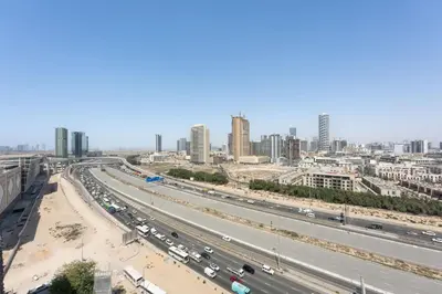 a highway in a city with a lot of traffic at StayShort - Sleek Studio in The Ivy Tower, JVT in Dubai