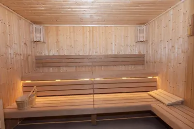 a sauna with a bench in a wooden room at StayShort - Sleek Studio in The Ivy Tower, JVT in Dubai