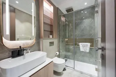 a bathroom with a sink and a shower and a toilet at StayShort - Sleek Studio in The Ivy Tower, JVT in Dubai