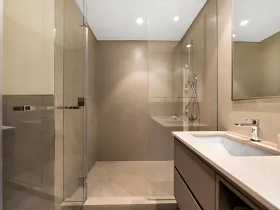 a bathroom with a shower and a sink at Crown Jewel 2 Bedroom Apartments I Iconic Burj Khalifa and Fountain Views I Free Parking, Gym, Pool, Wi-Fi and PS5 I by Skyline Serenity in Dubai