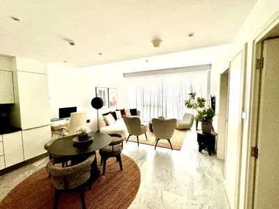 a living room with a table and a couch at The Pad by Omniyat in Dubai
