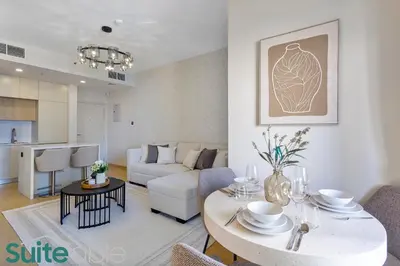 a living room with a table and a couch at Stylish 1 Bedroom near metro station in JLT in Dubai