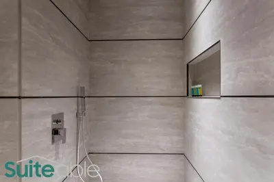 a bathroom with a shower with a mirror at Vibrant & Exclusive Pool View Studio in Autograph in Dubai