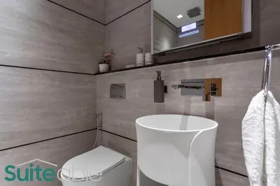 a bathroom with a white sink and a toilet at Vibrant & Exclusive Pool View Studio in Autograph in Dubai