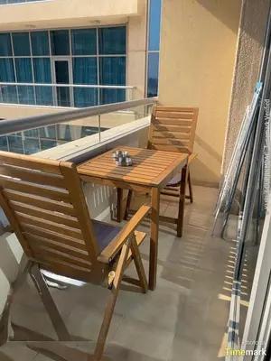 a wooden table and chairs on a balcony at Business Bay Mahek Holiday Home in Dubai