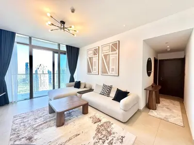 a living room with a couch and a table at Modern 2BR Skyline & Marina View in Dubai