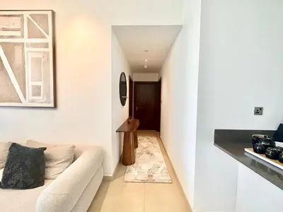 a living room with a couch and a table at Modern 2BR Skyline & Marina View in Dubai