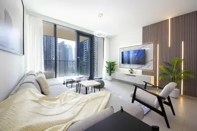 a living room with a couch and a tv at Spacious 2BHK Boulevard Heights Downtown in Dubai