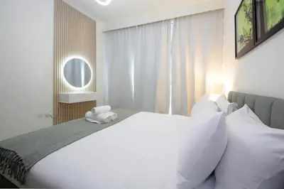 a bedroom with a large white bed and a window at Spacious 2BHK Boulevard Heights Downtown in Dubai