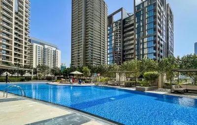 a large swimming pool in a city with tall buildings at Spacious 2BHK Boulevard Heights Downtown in Dubai