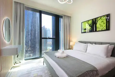 a bedroom with a bed with a stuffed animal on it at Spacious 2BHK Boulevard Heights Downtown in Dubai