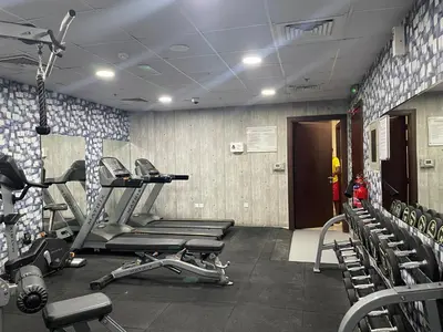a gym with several tread machines in a room at Ultra Luxury Chic 2Bed in Dubai in Dubai