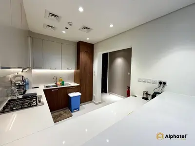 a kitchen with white counters and a counter top at Elegant 1-Bedroom Apartment in Dubai Silicon Oasis - by Alphatel Vacations in Dubai
