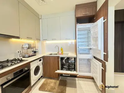 a kitchen with an open refrigerator and a dishwasher at Elegant 1-Bedroom Apartment in Dubai Silicon Oasis - by Alphatel Vacations in Dubai