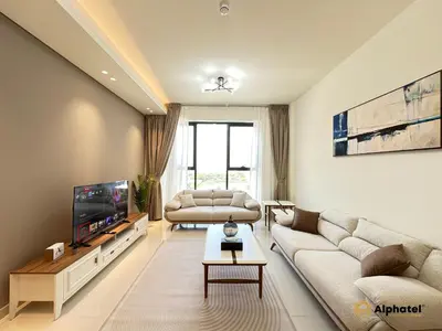 a living room with two couches and a tv at Elegant 1-Bedroom Apartment in Dubai Silicon Oasis - by Alphatel Vacations in Dubai