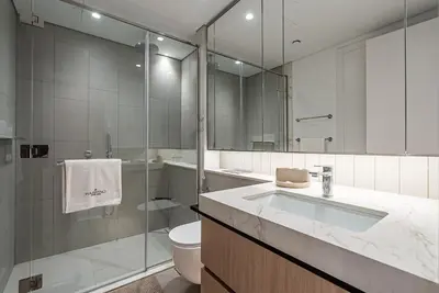 a bathroom with a sink and a toilet and a shower at Luxurious 1BDR apartment in MBR City in Dubai