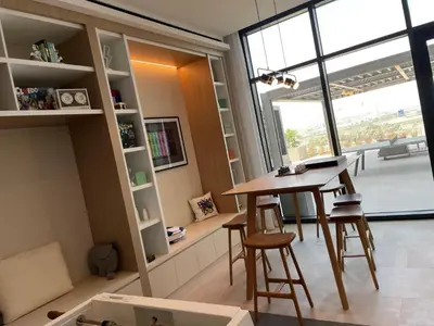 a room with a table and chairs and a large window at Luxurious 1BDR apartment in MBR City in Dubai