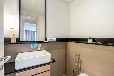 a bathroom with a sink and a mirror at Luxurious 1BDR apartment in MBR City in Dubai