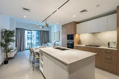 a kitchen with a table and a dining room at Luxurious 1BDR apartment in MBR City in Dubai