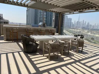 a patio with a table and chairs on top of a building at Luxurious 1BDR apartment in MBR City in Dubai