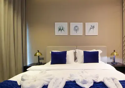 a bedroom with a bed with towels on it at Breathtaking Views Studio Apartment in Damac Prive in Dubai